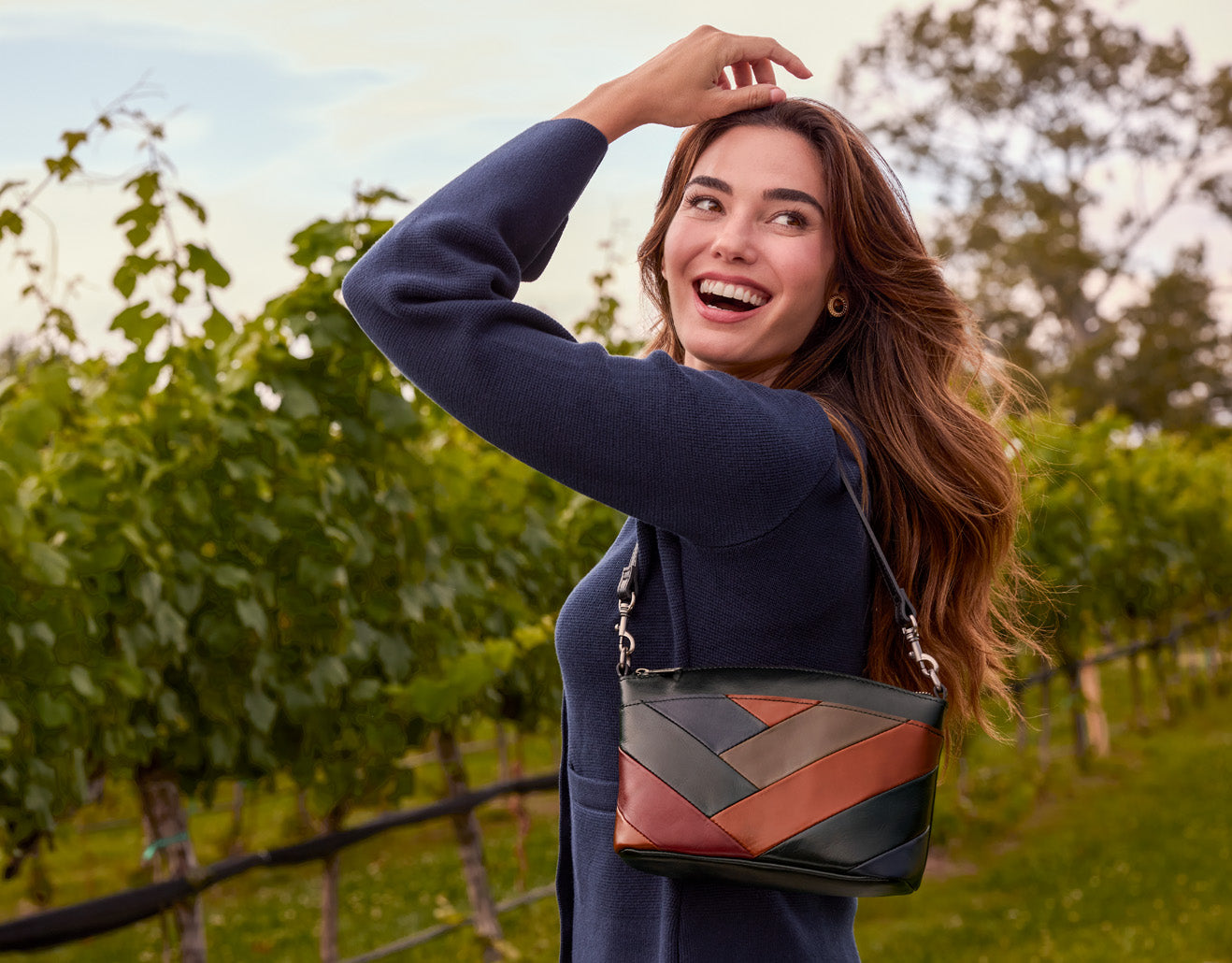 Colorblock shoulder bag by Patricia Nash, worn by model, artisan leather design in lifestyle setting