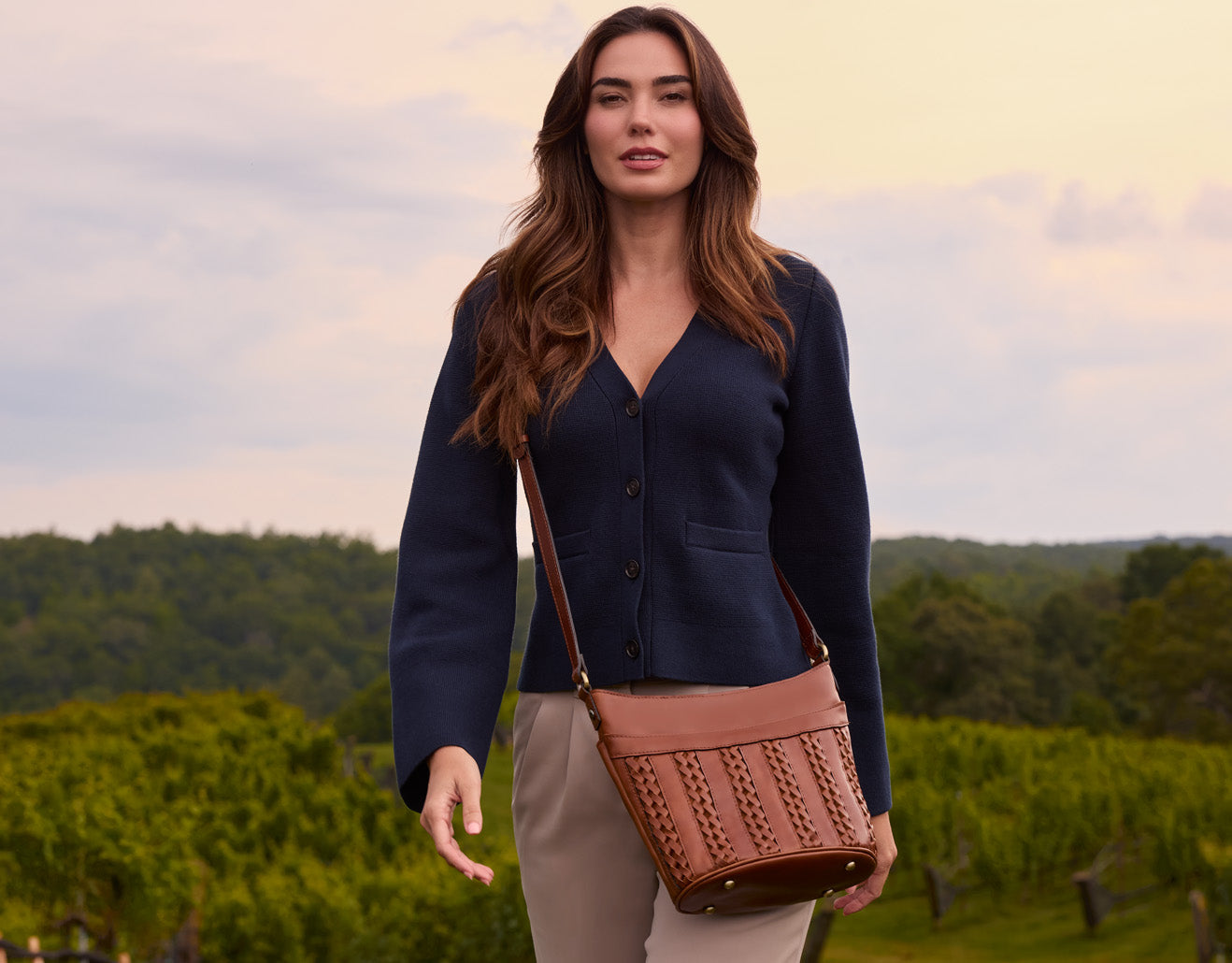 Model wearing Patricia Nash leather crossbody bag, hands-free artisan handbag in lifestyle setting