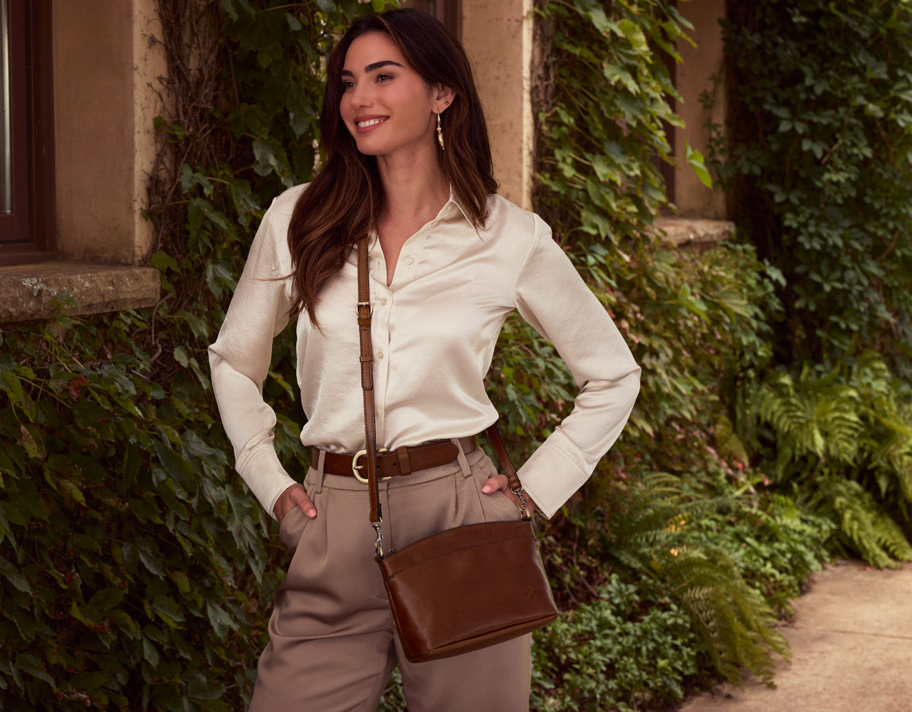 Model styled with vintage leather bag and belt by Patricia Nash, showcasing artisan-crafted accessories in lifestyle setting