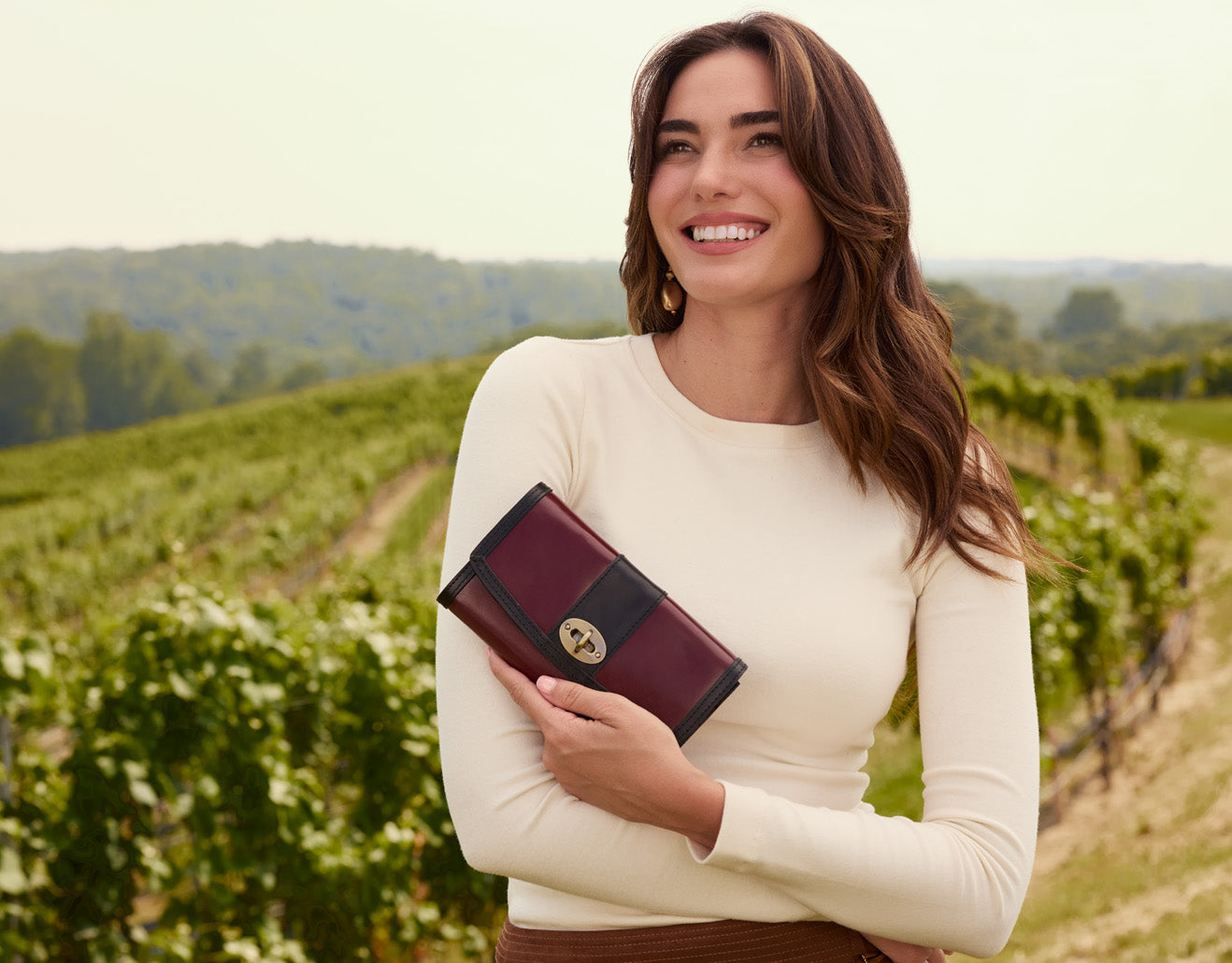 Model holding colorblock wallet by Patricia Nash, stylish leather accessory featured in lifestyle setting
