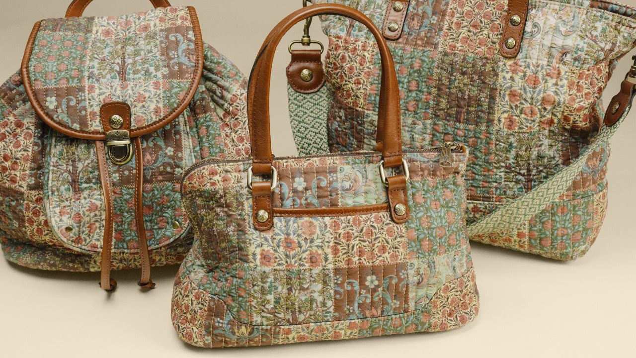 A coordinated set of patchwork quilted fabric handbags in earthy tones, including a backpack, a satchel with top handles, and a tote bag, all featuring brown leather trim and metal hardware on a light beige background.